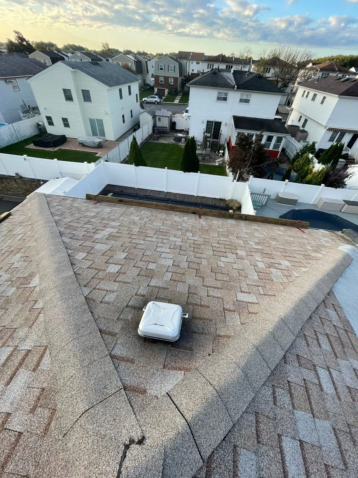 Finished new shingle roof with a ridge vent over a house