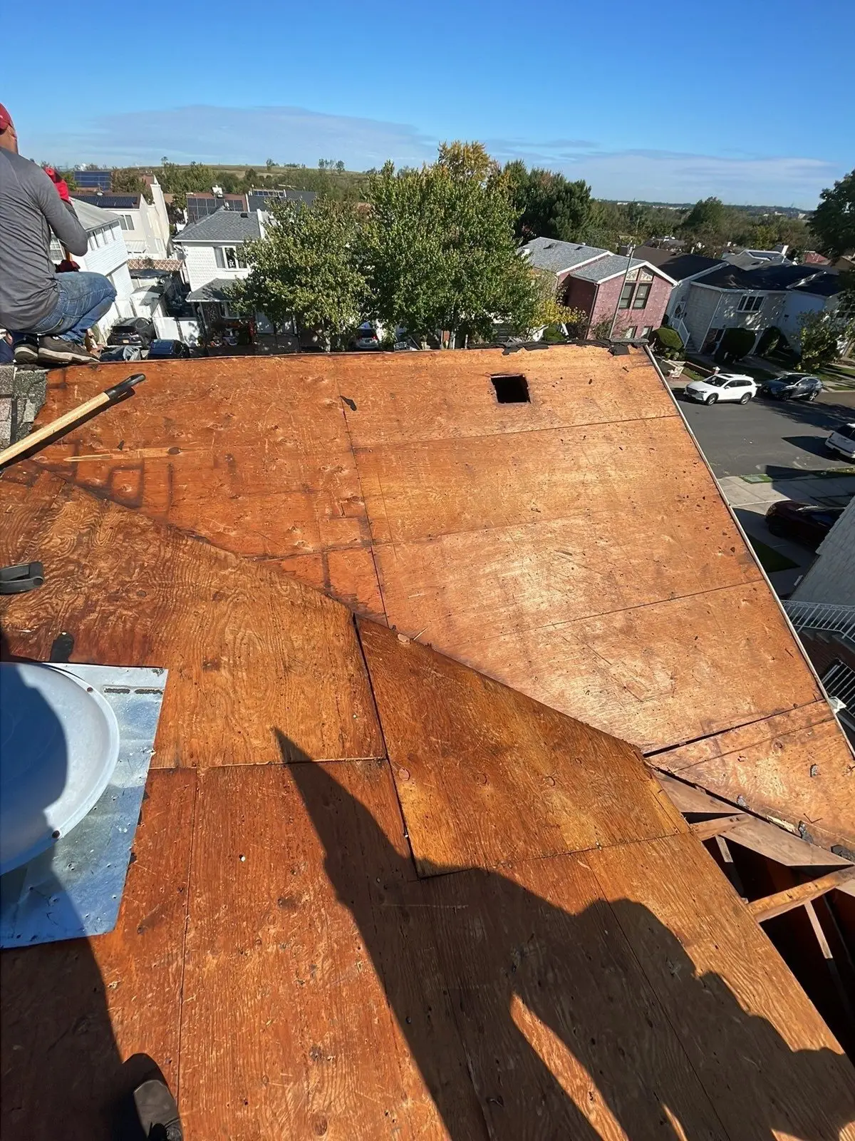 New plywood sheathing installed across a roof