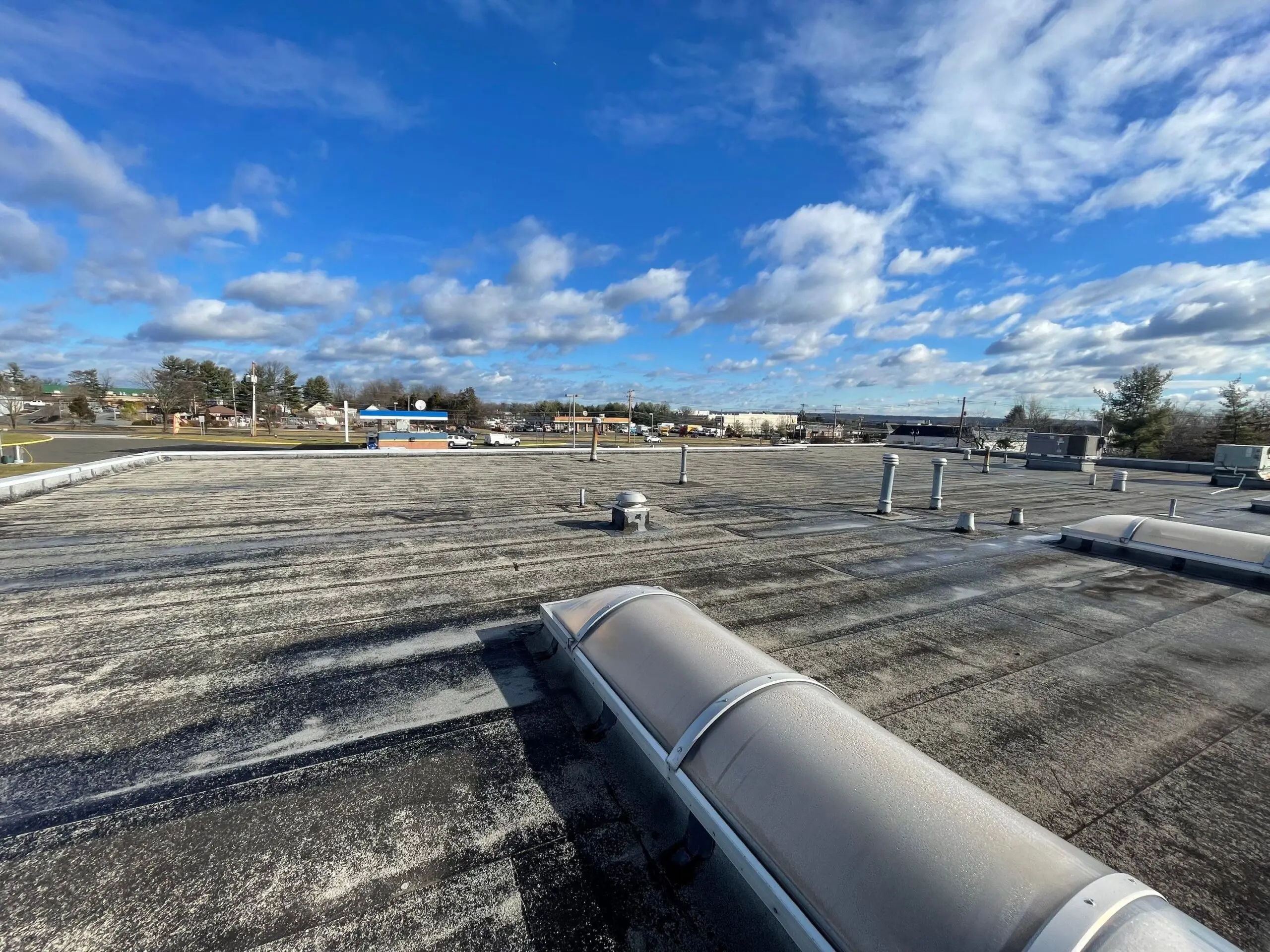 Commercial flat roof in Branchburg, New Jersey under a blue sky