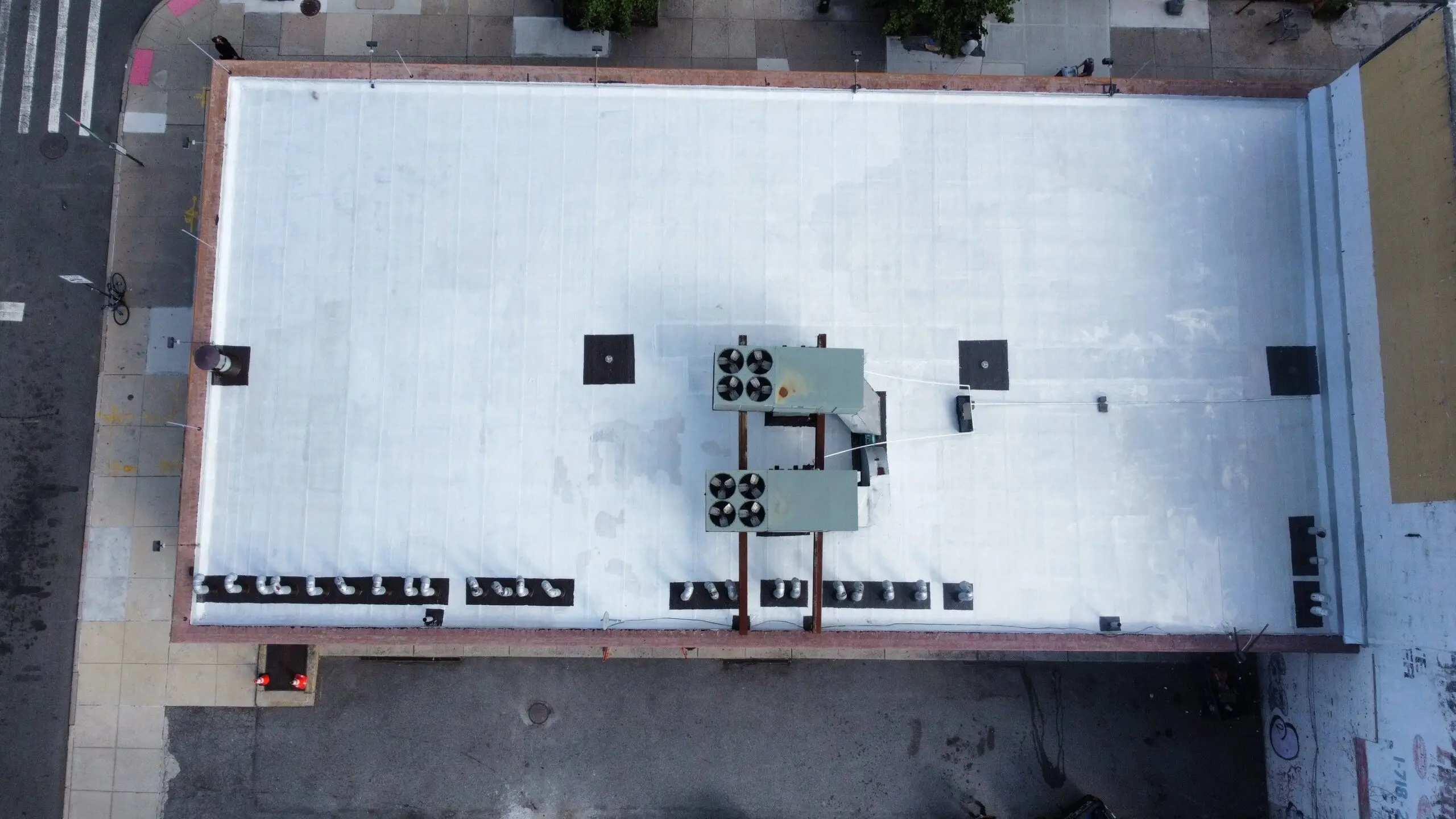 Large commercial flat roof with a new white membrane