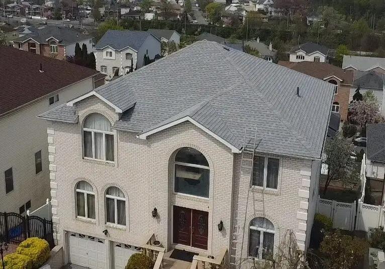 Large brick home on Michael Loop, Staten Island, with a new gray shingle roof
