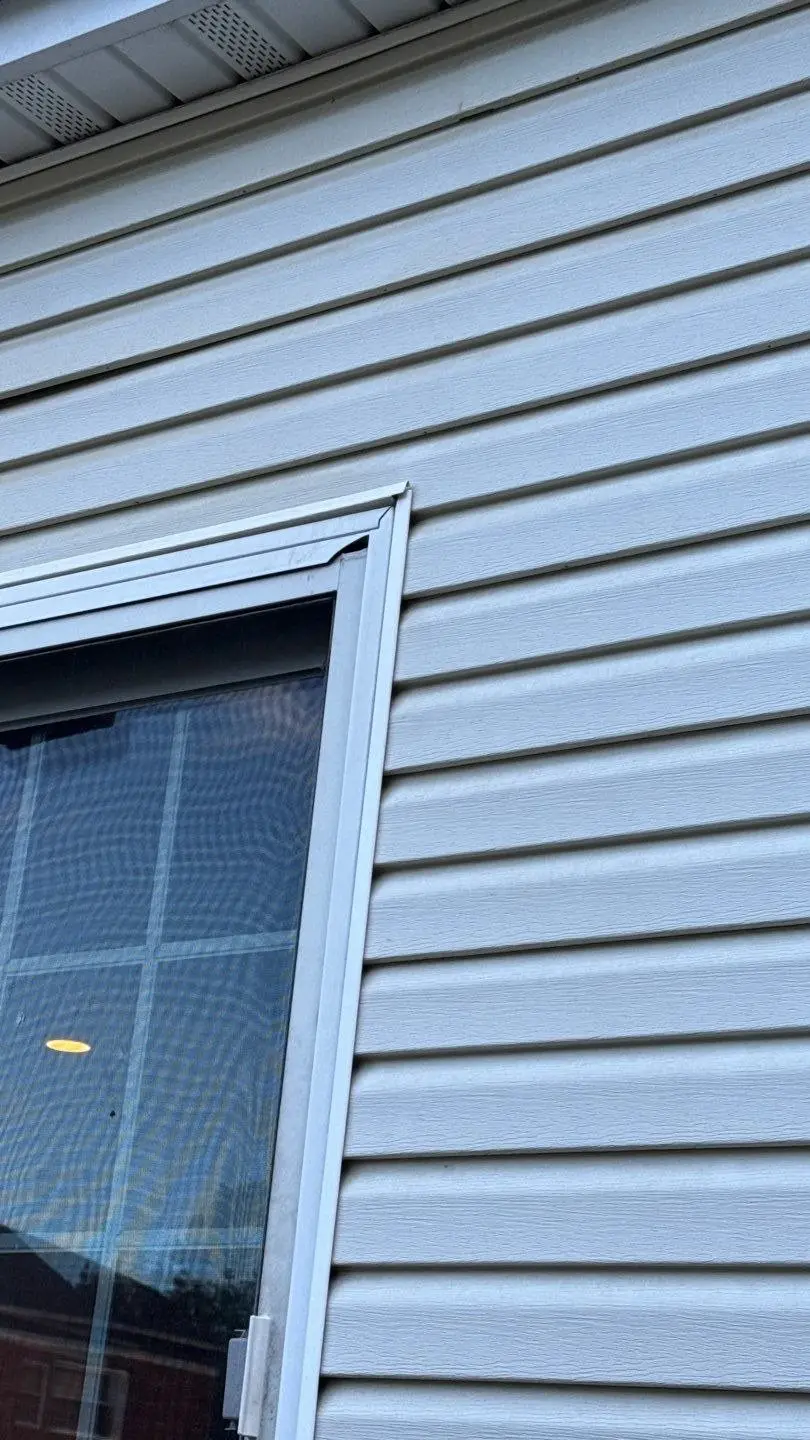 New light gray vinyl siding next to a window