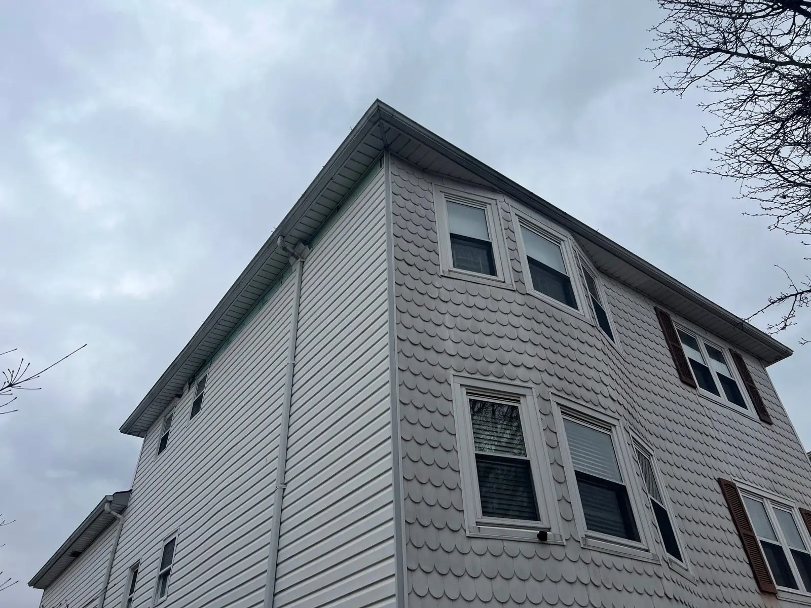 Two-story Staten Island home with vinyl siding and scalloped accent siding