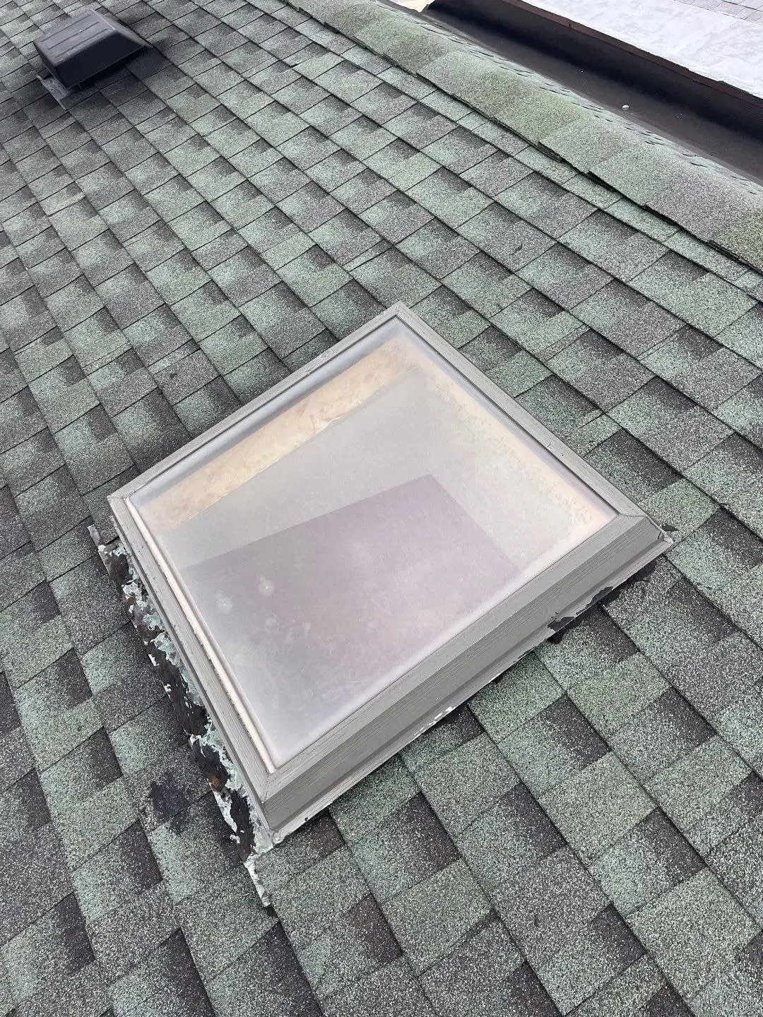 Skylight on a green shingle roof